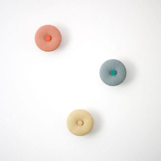 Upholstered wall hook Pad Hook with orange, green and yellow rohi textiles